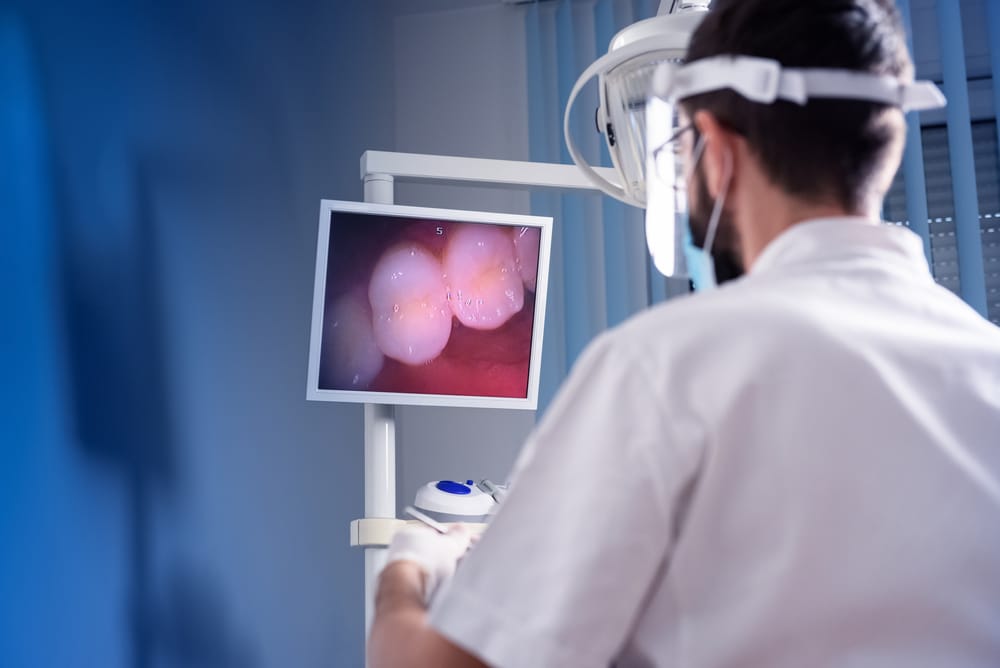Dentist,Checking,Patient's,Teeth,With,Dental,Camera